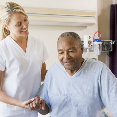 Nurse Helping Senior Man To Walk