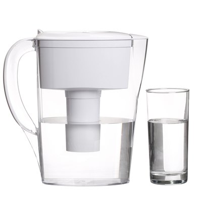 water filter jug with glass of clean water isolated