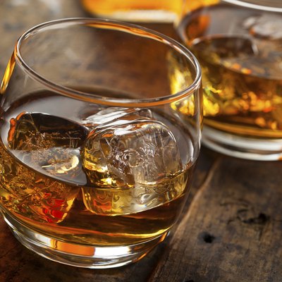 Alcoholic Whiskey Bourbon in a Glass with Ice