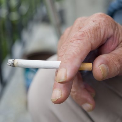 Holding Burning Cigarette