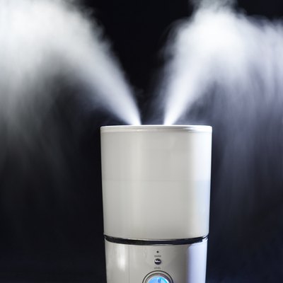 Humidifier spreading steam in darkness