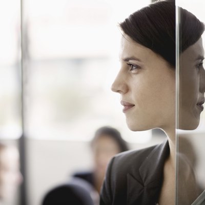 Side profile on a businesswoman with coworkers in the background