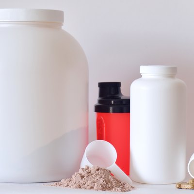 Big jar of protein powder, shaker, pills and tablets