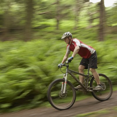 Male cyclist on track in countryside