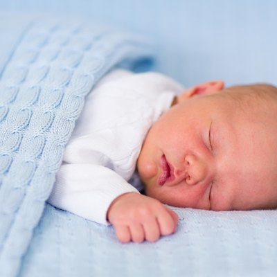 Newborn baby boy on a blue blanket