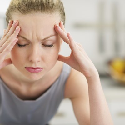 Portrait of stressed young housewife in modern kitchen