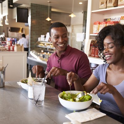 Couple Enjoying Lunch Date In Delicatessen Restaurant