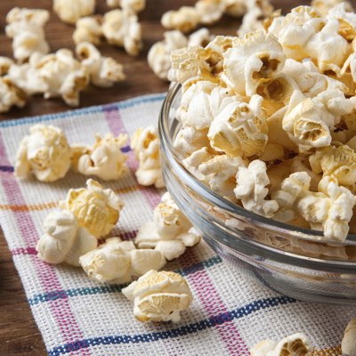 lot of salt popcorn into a bowl