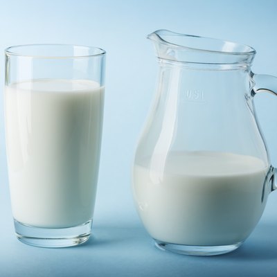 Glass jug and glass with milk