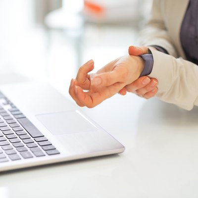 closeup on business woman with wrist pain