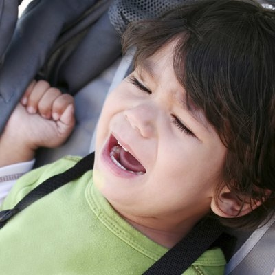 Unhappy toddler crying in stroller