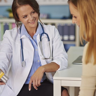 Doctor recommending vitamins to the patient