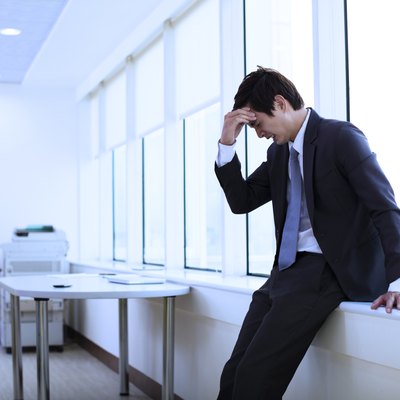 Depressed young businessman in office