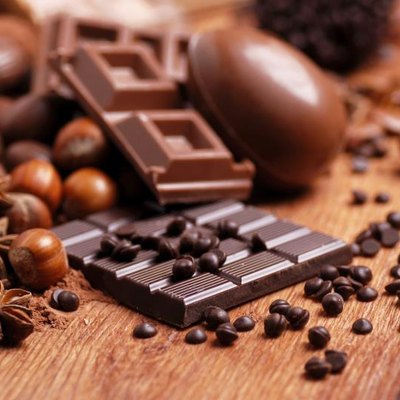 Easter eggs and assorted chocolate on wooden table