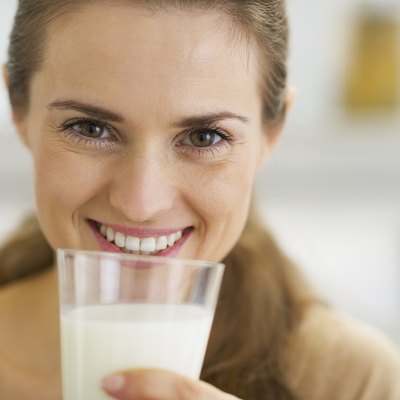 happy young woman drinking milk