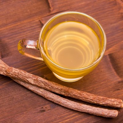 Herbal tea licorice inside cup on wood from above