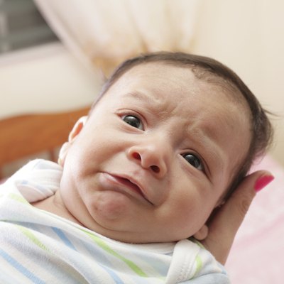 Woman holding a newborn crying