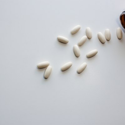 Pour off vitamin C on a white background