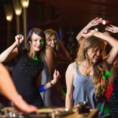 Happy friends dancing by the dj booth