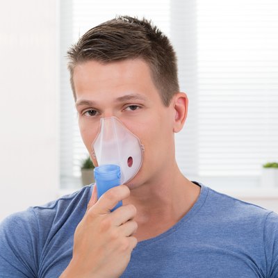 Man Inhaling Through Inhaler Mask