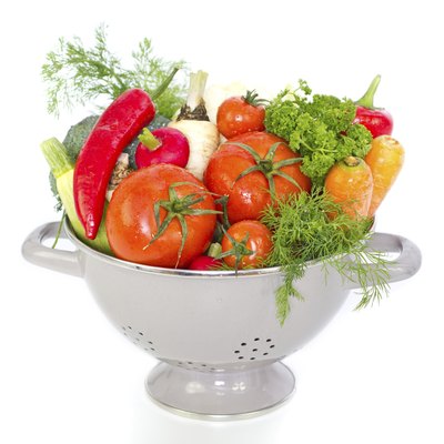 Fresh vegetables in metal colander