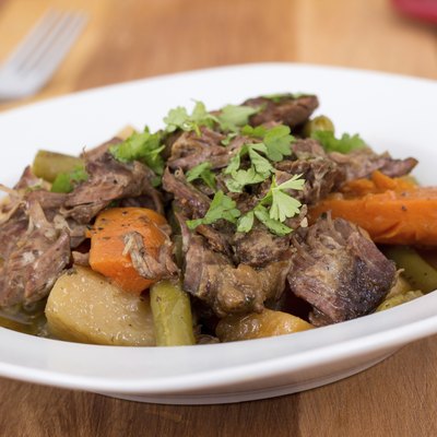 braised beef pot roast stew with vegetables on table
