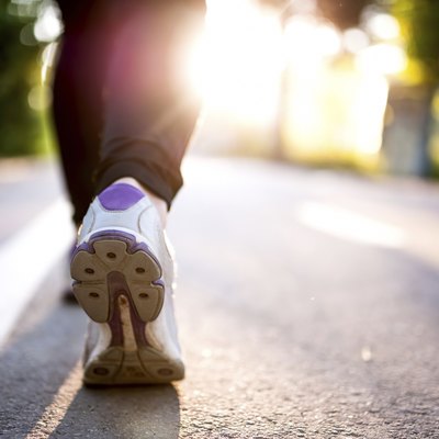 Close-up of Athlete shoes while running in park. Fitness concept