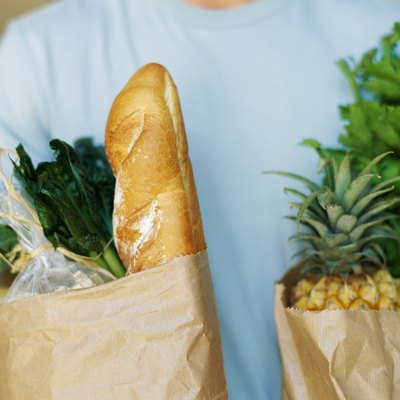 mid section view of a person holding shopping bags