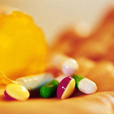 Bottle of pills in hand