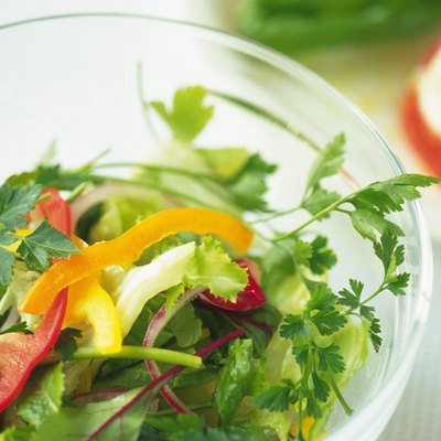 Mixed salad leaves in bowl, another salad visible in background, Differential Focus