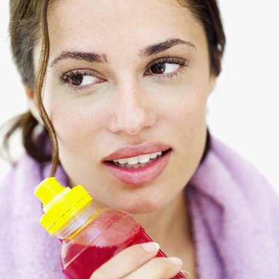 Close-up of a young woman holding a bottle