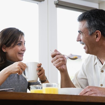 Middle-aged couple eating breakfast