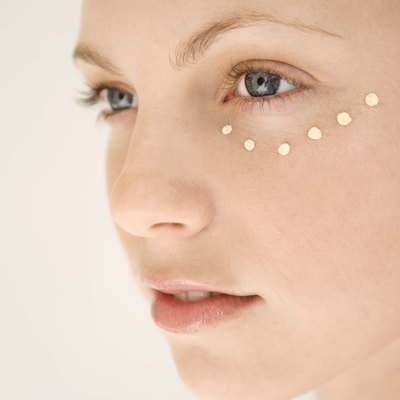 Woman with dots of moisturizer