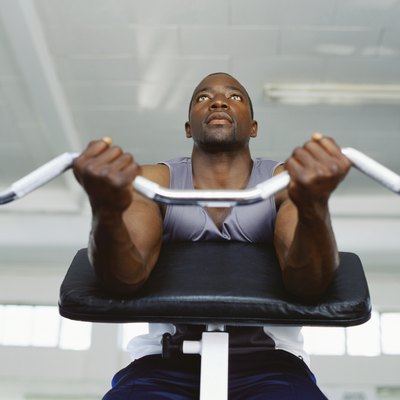 Low angle view of a mid adult man exercising in the gym with weights