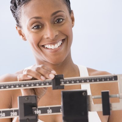 African American woman weighing self