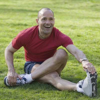 Hispanic man exercising in a park and smiling