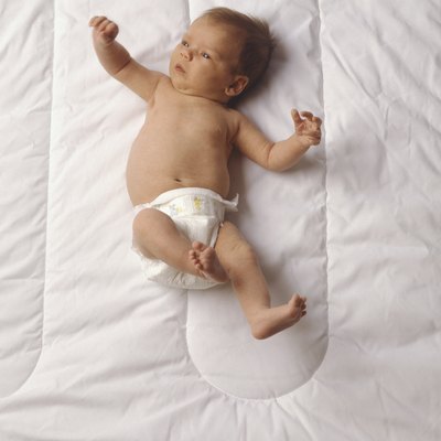 Baby (3-6 months) lying on bed