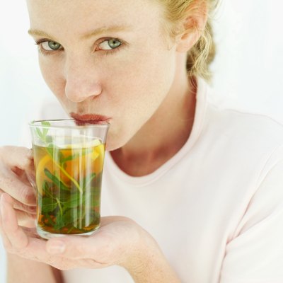 woman sipping a glass of iced tea