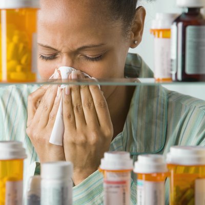 African American woman blowing nose