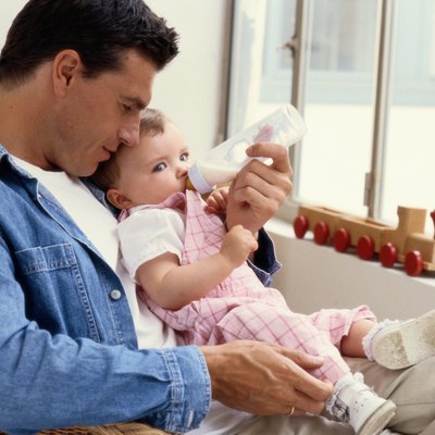 Father Bottle-Feeding His Young Daughter