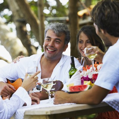 South American man playing guitar for friends