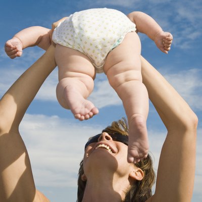 Mother holding baby up in air