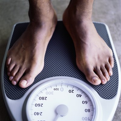 Feet of man on weight scale