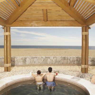 Couple in hot tub outdoors at beach resort