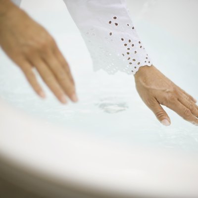 Woman testing bath water