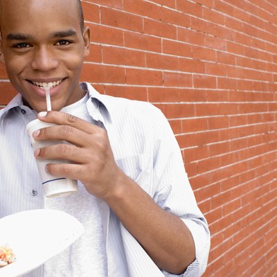 Smiling man with pizza and beverage