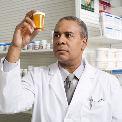 Pharmacist looking at a pill bottle