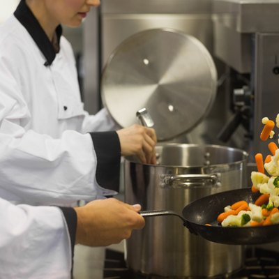 Two chefs working in a busy kitchen