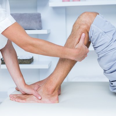 Physiotherapist doing calf massage to her patient