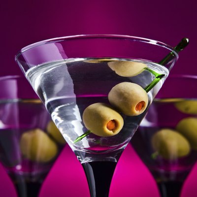 glasses with martini and green olives